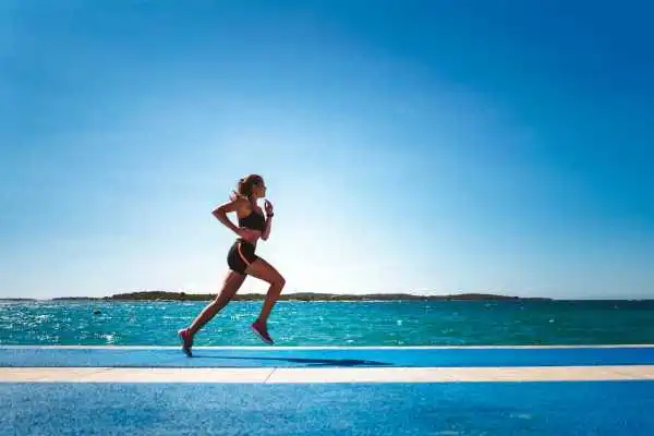 Woman running showing strong leg muscle Enfield